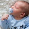 newborn baby's face with red rash acne and pimples