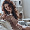 woman happy pregnancy test