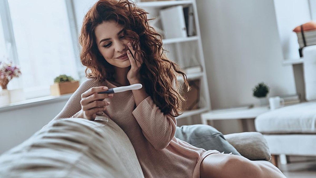 woman happy pregnancy test