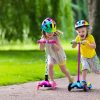 Children learn to ride scooter in a park